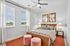 Bright, charming bedroom featuring a comfortable bed, stylish decor, and large windows inviting natural light.