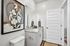 Contemporary bathroom with elegant granite countertop, tasteful wall art, and modern fixtures, offering a serene and stylish retreat.