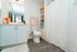 Modern bathroom with elegant fixtures, a spacious countertop, and vibrant decorative accents, offering a serene and inviting atmosphere.