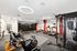 Modern fitness center with sleek design, featuring exercise bikes, treadmills, and a multi-station gym system under contemporary lighting.