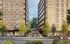 Modern urban development featuring two elegant apartment buildings, lush greenery, and inviting communal spaces.
