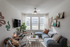 Bright and cozy living room with modern decor, large sectional sofa, and ample natural light from large windows.