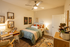 Charming bedroom with cozy decor, stylish artwork, and elegant lighting, perfect for relaxation.