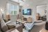 Chic living area with stylish furniture, modern decor, and flat-screen TV, adjacent to a cozy bedroom, perfect for urban living.