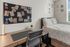 Inviting bedroom with stylish workspace, cozy bed, and inspirational decor, perfect for productivity and relaxation.