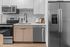 Modern kitchen with sleek stainless steel appliances, stylish cabinetry, and elegant backsplash.