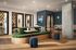 Modern co-working space with stylish green seating, individual desks, vibrant decor, and ample natural light.
