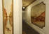 Elegant hallway with classic wall art featuring European cityscape and scenic lake view, evoking a sense of timeless charm.