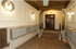 Elegant apartment entryway featuring classic wall sconces, intricate ceiling design, and secure mailboxes.