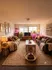 Cozy living room featuring elegant sofas, warm lighting, and decorative plants, creating an inviting atmosphere.