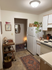 Charming kitchen with white cabinetry, cozy decor, and lush green plants adding a touch of nature.