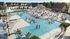 Vibrant community pool area with luxurious sun loungers, stylish cabanas, and a lively atmosphere of people enjoying the sparkling blue water.