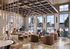 Inviting communal space with modern seating, large windows providing natural light, and a vibrant social atmosphere.