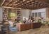 Inviting lounge area with comfortable seating, elegant wood accents, and a modern TV setup, perfect for socializing or working on a laptop.