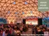 Vibrant gathering in a modern geodesic dome featuring elegant decor and social interactions, highlighting Baker House amenities.