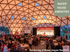 Vibrant event under a stunning geometric dome at Baker House Mansion, featuring a welcoming atmosphere with attendees socializing and engaging in lively conversations.
