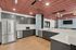 Modern kitchen with sleek gray cabinets, stainless steel appliances, and wood flooring, perfect for stylish living.