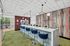 Modern communal area with sleek bar seating, vibrant wall art, and contemporary light fixtures, offering a stylish and welcoming space for interaction.