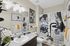 Chic modern bathroom with artistic decor, bold graphic shower curtain, and stylish vanity lighting.