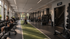 Modern gym facility with large windows, weightlifting equipment, and a central turf track for dynamic workouts.