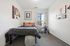 Bright and cozy bedroom featuring modern decor, a comfortable bed, and a scenic window view, perfect for relaxation and study.