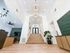 Inviting apartment lobby with modern lighting, elegant wooden staircase, and stylish decor accents.