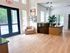 Bright and modern apartment lobby featuring elegant lighting, a welcoming seating area, and sleek wooden flooring.