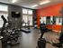 The Villas of Castleton gym with various exercise machines and mirrors reflecting the workout space.