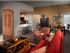 Open concept with red couches, kitchen table, and kitchen at The Crest at Elm Tree.