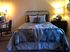 A welcoming bedroom at The Villas of Castleton, complete with a bed and a desk for relaxation and productivity.