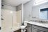 Bright bathroom at The Villas of Castleton, showcasing a shower, toilet, and sink in a welcoming space.