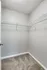 A closet with a white door stands on a carpeted floor at The Villas of Castleton.