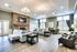 Inviting living room area of the Villas of Castleton clubhouse, showcasing a warm atmosphere.