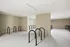 A well-organized room with a bike rack displaying a couple of bikes, ideal for cycling lovers and urban dwellers at Lofts at Yard 56.