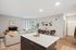 Lofts at Yard 56 two bedroom apartment with a bright kitchen and a comfortable living room, exuding a fresh and tidy vibe.