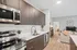 Stylish kitchen equipped with stainless steel appliances and a microwave, blending functionality with modern aesthetics at Lofts at Yard 56.