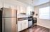 A modern kitchen featuring sleek stainless steel appliances and warm wood floors, creating a stylish and inviting atmosphere at Westview Commons.