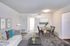 A bright living room with a stylish couch, a dining table at Westview Commons Apartments, and a TV are perfect for relaxation and gatherings.