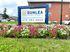 Sign for Dunlea Apartments in Dundalk, MD, displayed prominently in front of the building.