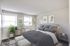 Bright Meadows Townhomes bedroom showcasing a gray bed paired with a sleek white dresser for a modern touch.