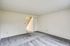 Spacious empty living room in Bright Meadows Townhomes with carpet and stairs leading to the second floor.