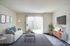 Welcoming living room at Bright Meadows Townhomes, featuring a couch, coffee table, and television for a perfect hangout spot.