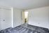 Inviting bedroom in Bright Meadows Townhomes, showcasing plush carpet and fresh white walls for a serene vibe.