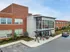Front view of Lancaster Lofts featuring parked cars, highlighting the building's stylish exterior design.