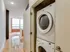 A compact washer and dryer set in a cozy hallway at Lancaster Lofts, maximizing space and convenience.