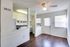 Modern white kitchen with beautiful wood floors.
