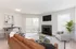 Inviting living room in Hampton Point Apartment showcasing a couch, chair, and television for a warm, homey atmosphere.