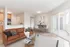 Bright living room in Hampton Point Apartment with a comfortable couch, stylish coffee table, and adjoining kitchen.