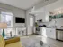 Stylish kitchen and living room combo in 500 Park Avenue Apartments, complete with a television for relaxation.