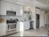 Stylish kitchen in 500 Park Avenue Apartments with sleek stainless steel appliances and a comfortable couch for lounging.